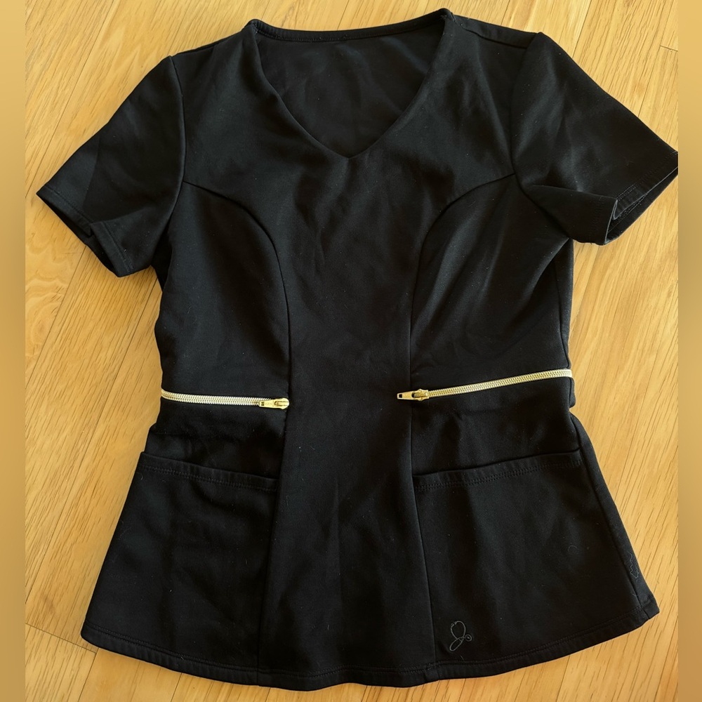 Black Jaanuu Scrub top with gold zipper accents